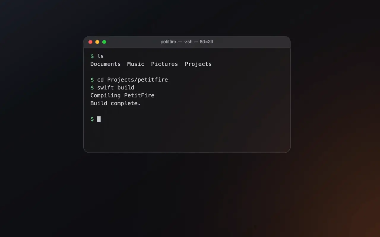 The bottom right corner of a dark Mac screen, with a warm candle light on the edge